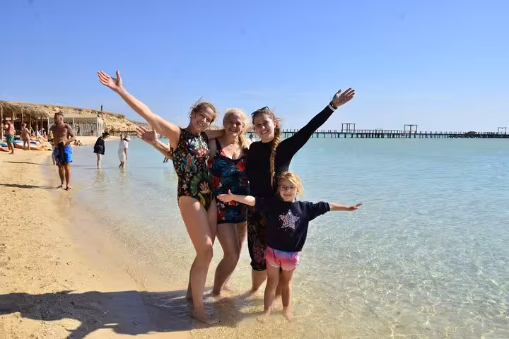Family enjoying shallow lagoon at Orange Bay, Giftun Island on Hurghada boat trip with snorkeling and lunch