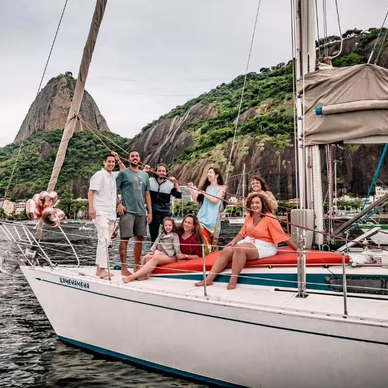 Family group posing on a yacht near Sugarloaf Mountain, experiencing Rio's vibrant coastal scenery.