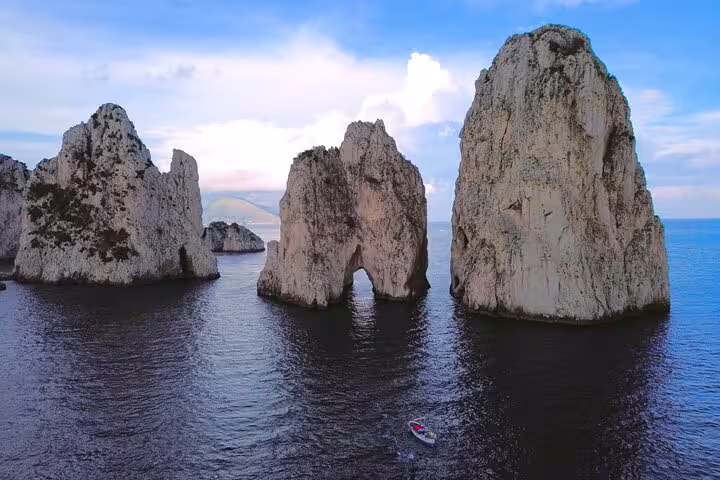 Faraglioni rocks of Capri seen from the sea on a 4h private classic boat tour, iconic seascape