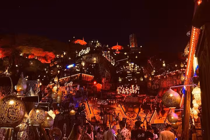 Night view of Farsha Mountain Lounge in Sharm El-Sheikh with lanterns, crowd, and shisha cafe atmosphere