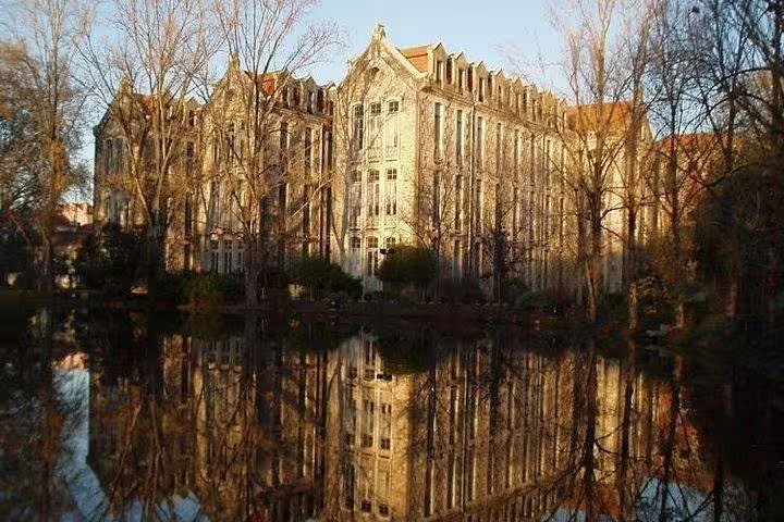 Stunning reflection of a historic building on a serene lake in Portugal's picturesque landscape.
