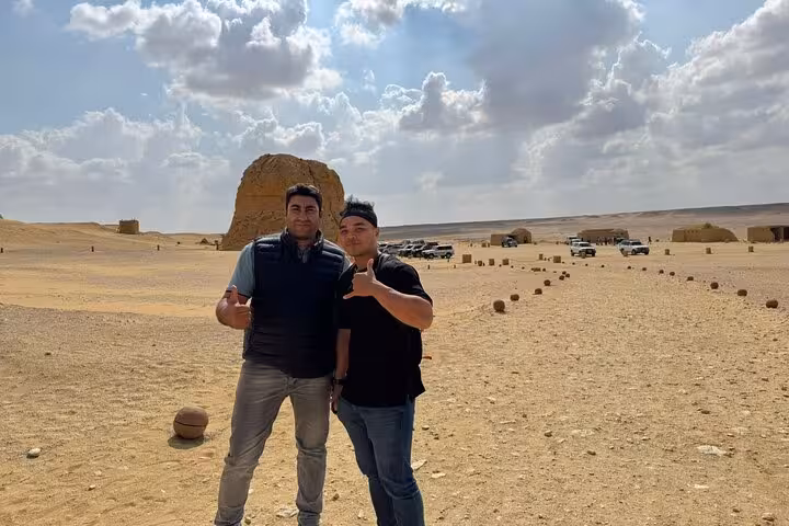 Travelers pose in Egypt’s Fayoum desert on a private full-day tour from Cairo with 4x4 safari views