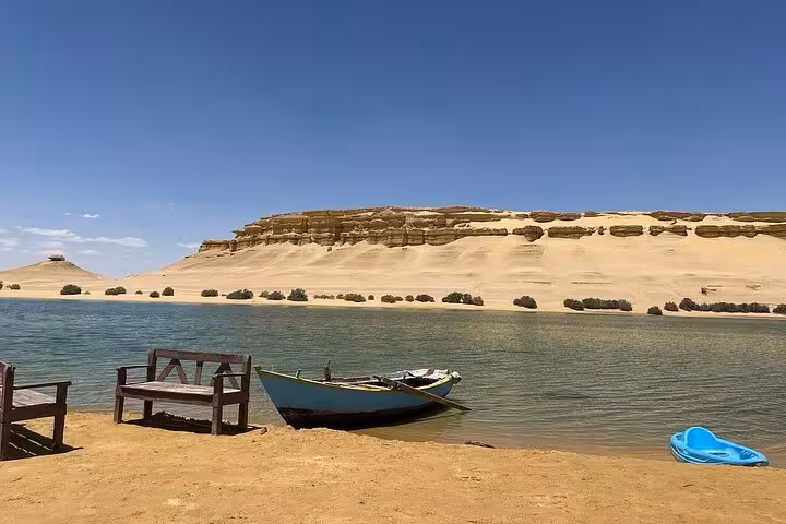 Boat on Lake Qarun with desert cliffs, a Fayoum oasis stop on the Nature, History and Handcrafts tour