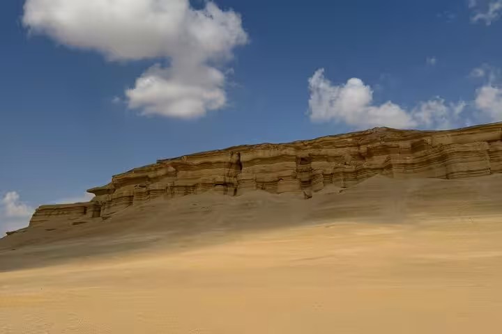 Layered desert cliffs and golden dunes in Fayoum Oasis on a private full-day tour from Cairo, Egypt