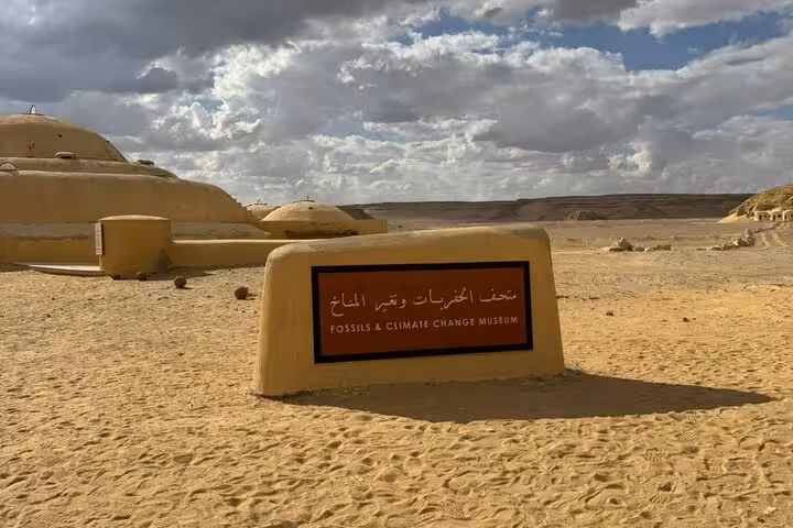 Fossils & Climate Change Museum sign in Wadi El Hitan desert on Fayoum Oasis private day tour from Cairo