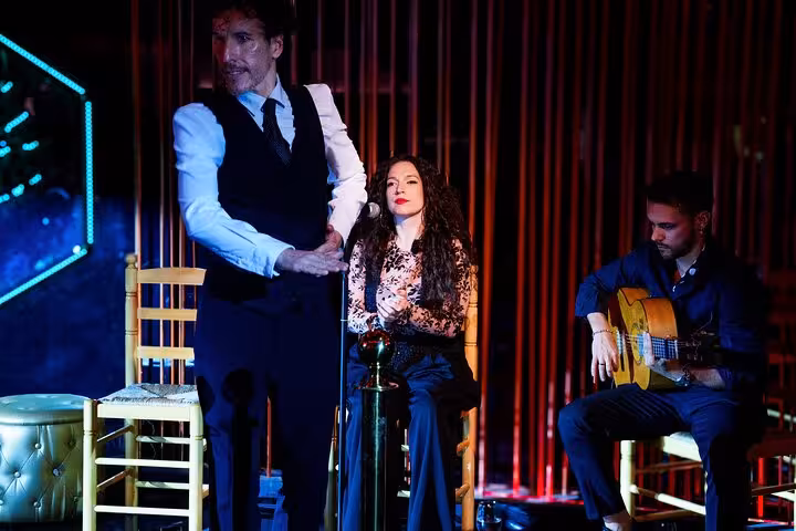 Energetic flamenco dancer captivates the crowd alongside talented musicians at a live show with tapas in Barcelona.