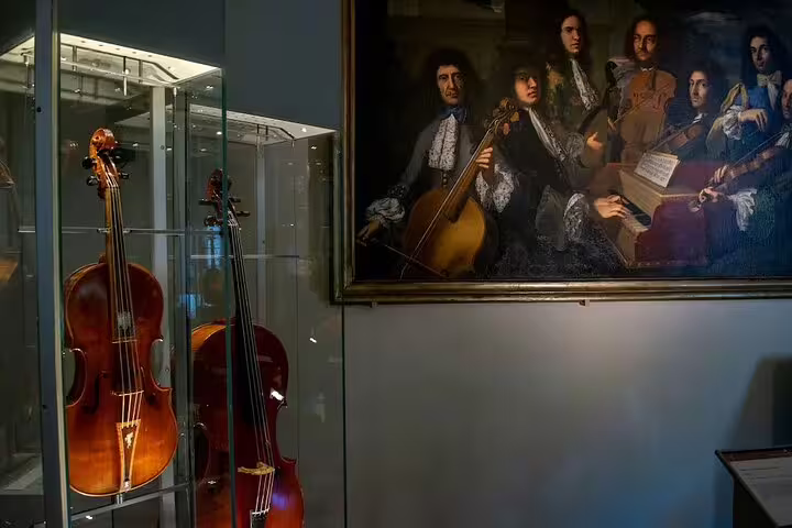 Historic string instruments and baroque musicians painting displayed in Accademia Gallery on a guided Florence art tour