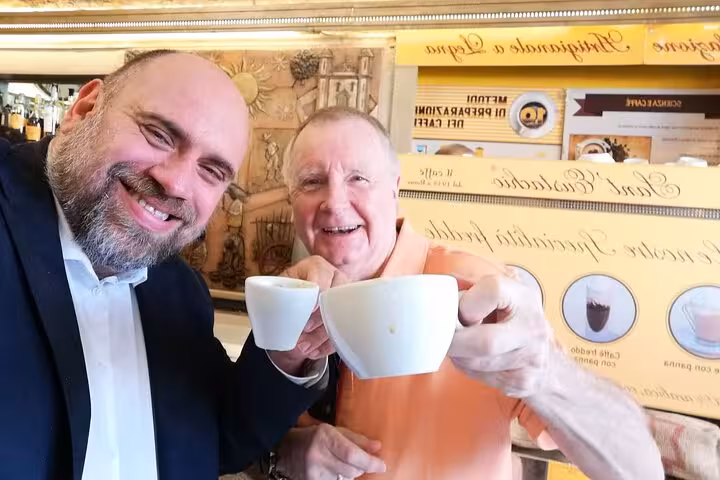 Tour guests toasting espresso in a Florence cafe on a Rome to Florence day trip, enjoying authentic Italian culture