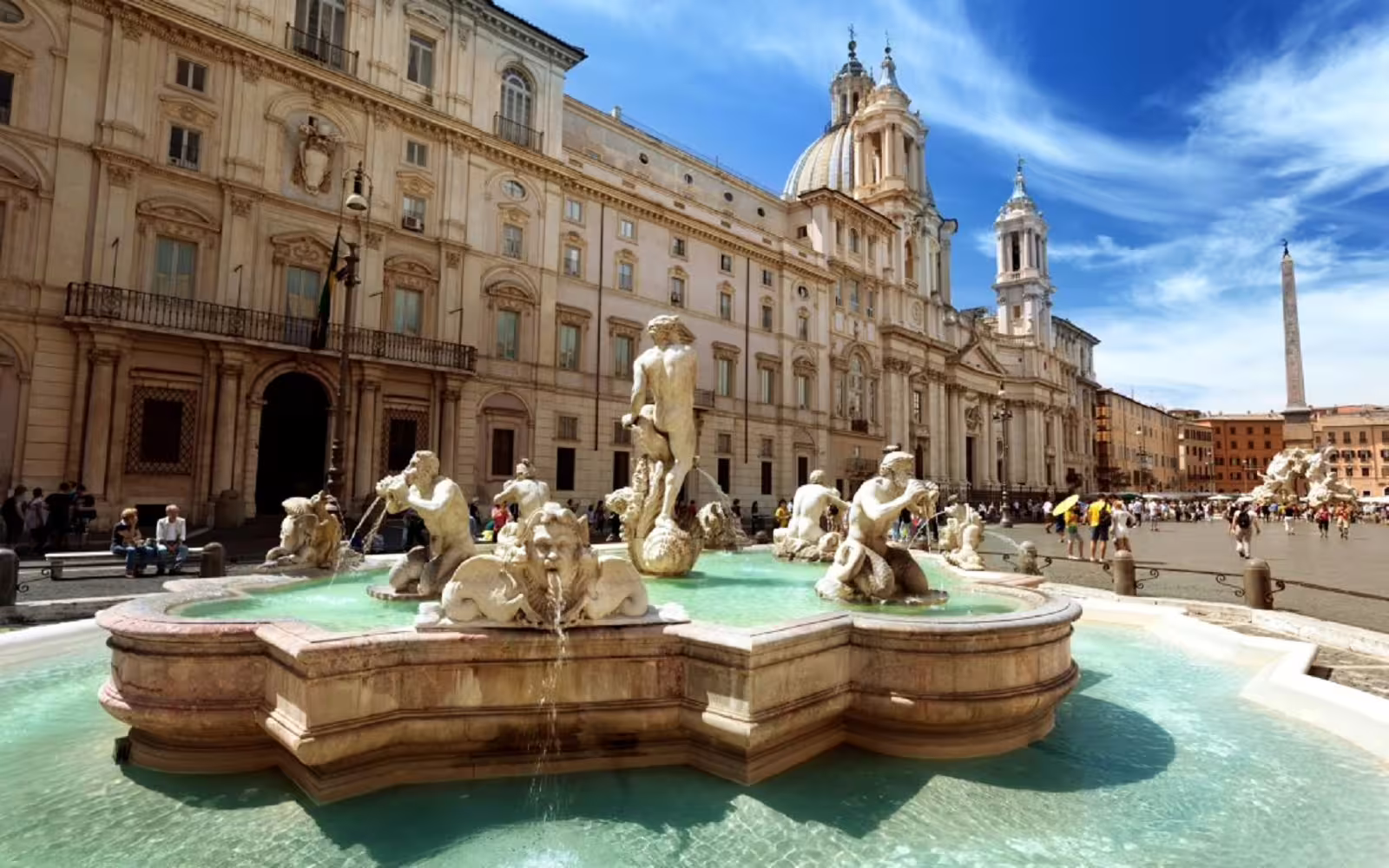 Travelers admire Fontana del Moro in Piazza Navona, Rome, during a guided fountains and historic squares walking tour