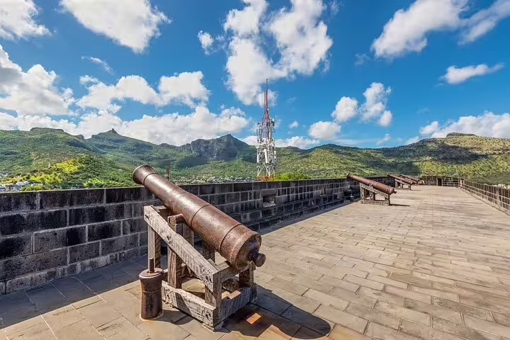 Old cannons on Fort Adelaide Citadel terrace with mountain views, featured on a North Mauritius private adventure