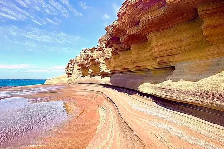Stunning layered rock formations at Françes Beach, São Nicolau, under a clear blue sky on a full-day island tour.