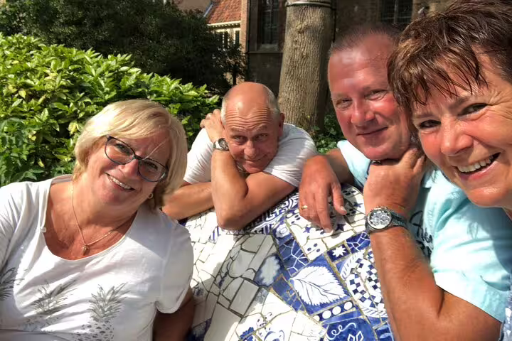 Friends smiling over a city map, taking part in a self-guided London e-scavenger hunt walking tour