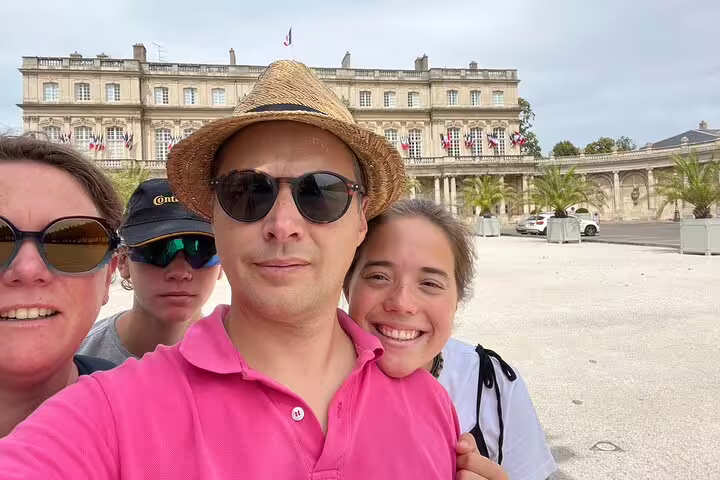 Friends taking a selfie at Place Stanislas, Nancy during an e-scavenger hunt, self-guided city discovery game