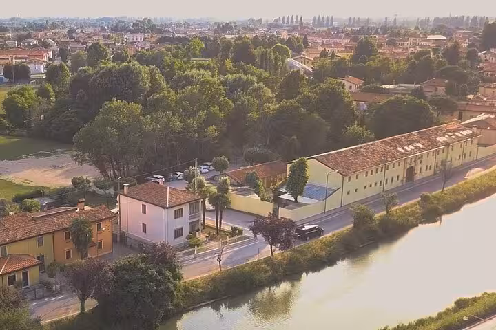 Scenic aerial view of lush greenery and charming buildings near Fusina, ideal for Venice cruise transfers.