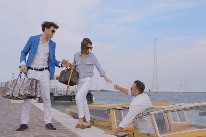 Couple disembarking from a water taxi at Fusina terminal, highlighting convenient Venice transfer services.