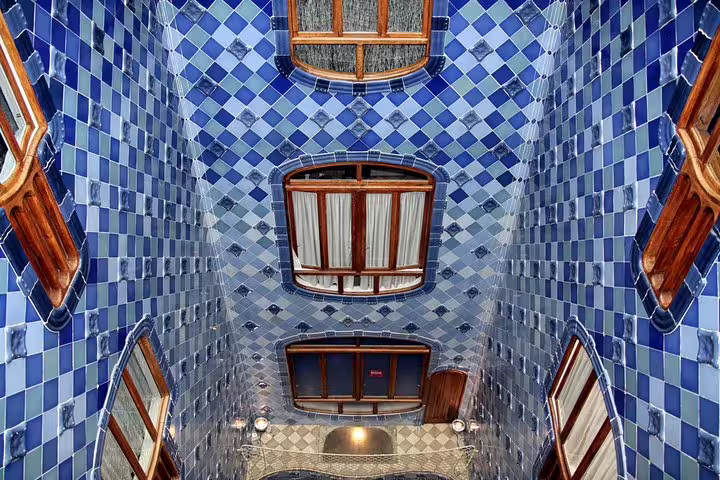 Stunning view of Casa Batlló's vibrant blue tiled courtyard, showcasing Gaudí's architectural genius on a private tour.