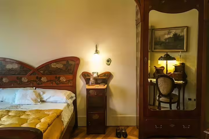 Elegant bedroom with vintage furniture in Casa Vicens, showcasing Gaudí's intricate design during private skip-the-line tour.