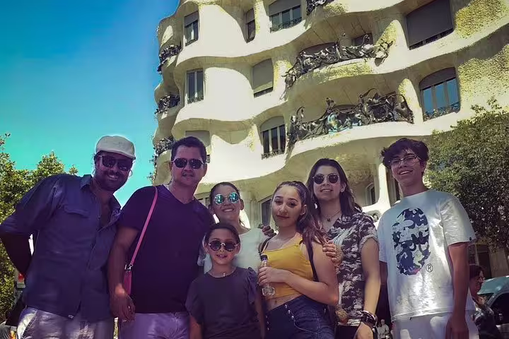 Tourists enjoy a sunny day at Gaudí's iconic La Pedrera in Barcelona, part of a private skip-the-line tour of Gaudí houses.