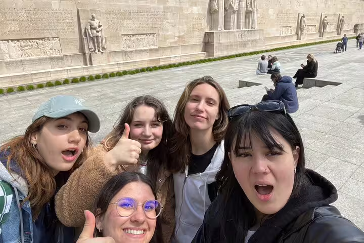 Group selfie at Geneva Reformation Wall during a city highlights scavenger hunt walking activity in Old Town