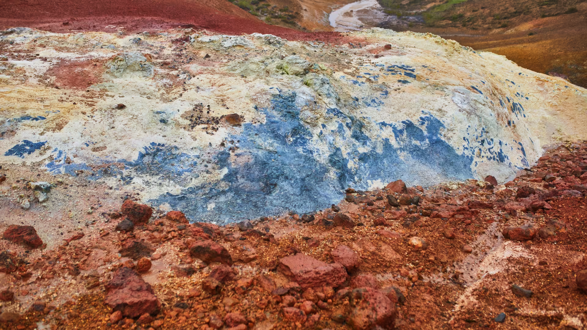 Colorful mineral-stained geothermal ground in Krýsuvík, Iceland, on a fast-paced hiking sprint tour