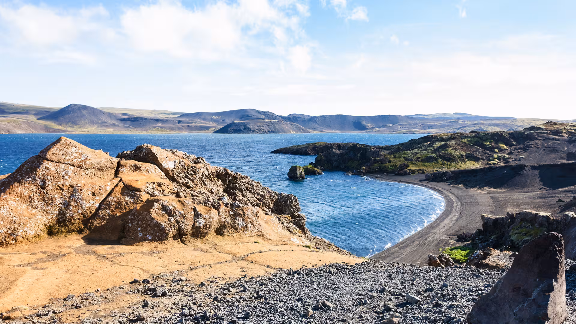Black sand cove and rugged lava coast near Krýsuvík on an Iceland geothermal sprint adventure tour