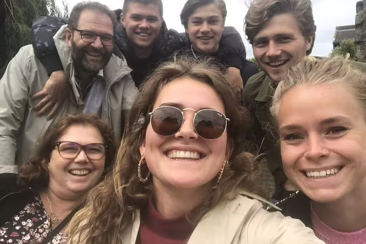 Group selfie on a Ghent e-scavenger hunt, city exploration game with clues and teamwork outdoors