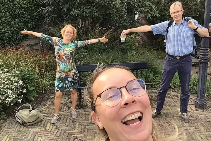 Smiling team posing outdoors during the Ghent e-scavenger hunt, a self-paced walking tour with puzzles