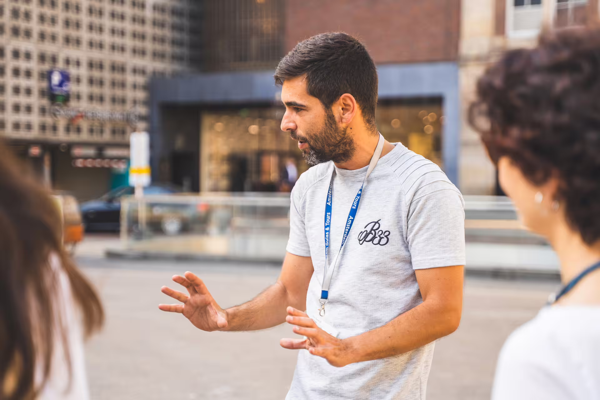 Tour guide passionately explaining Ghent's historical landmarks during a private walking tour in the heart of Flanders.