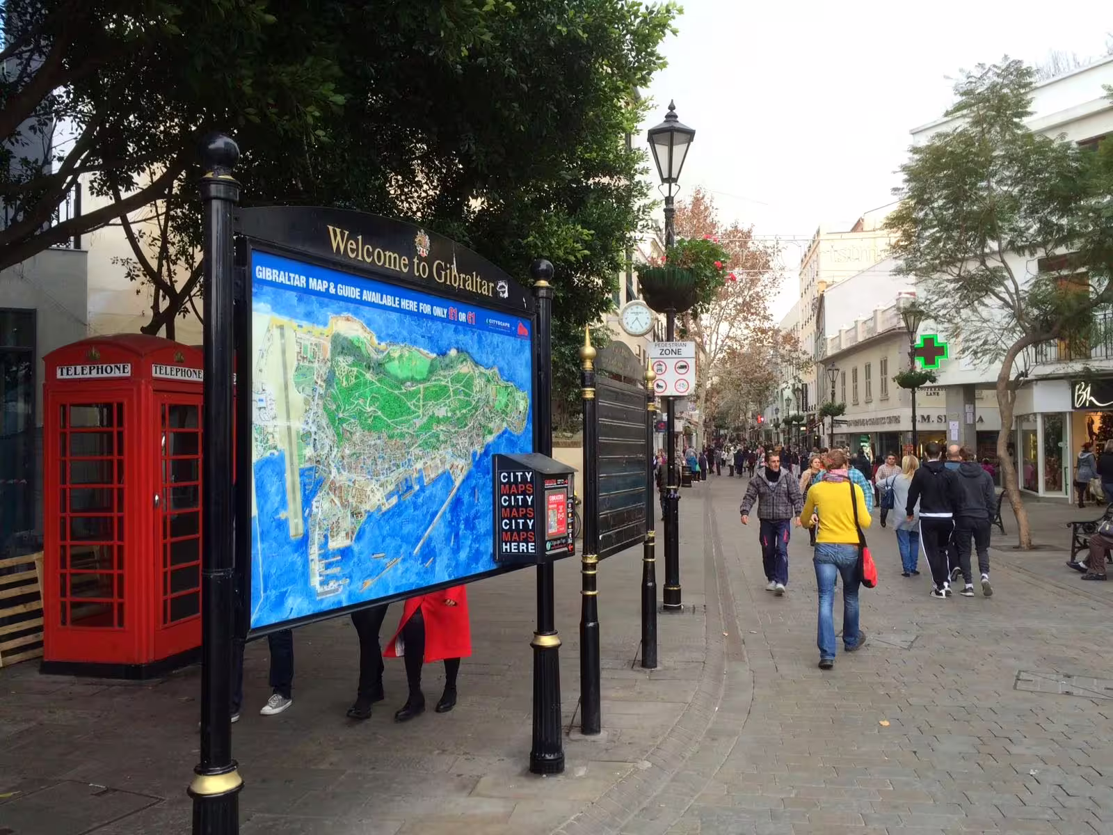 Gibraltar city center map sign by red phone booths, key stop on private tour from Costa del Sol