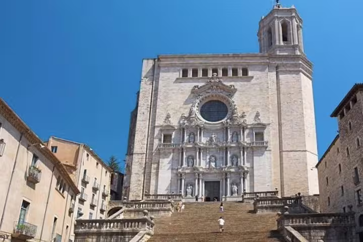 Impressive facade of a historic cathedral with grand steps, ideal for exploring on a Girona private tour.