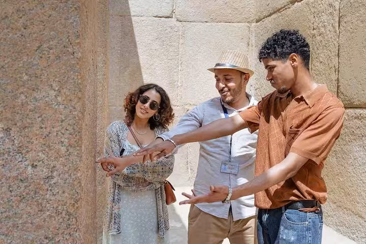 Guide briefing visitors inside Great Pyramid passage on Giza, Sphinx and Saqqara Serapeum private tour