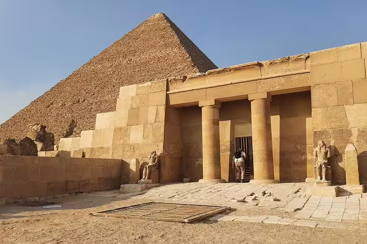 Entrance of a Giza pyramid temple with columns and statues, must-see on Cairo pyramids day tour