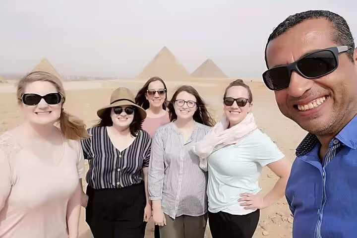Group selfie with local guide at the Pyramids of Giza, part of Cairo day tour including Egyptian Museum and Khan El Khalili
