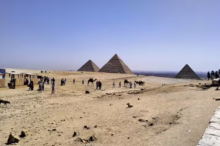 Giza Pyramids panorama near Cairo with desert visitors and camels, key stop on 6-day Egypt Cairo Aswan felucca trip