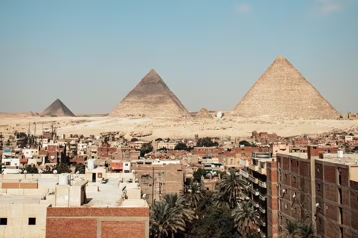 Panoramic view of Giza Pyramids above Cairo rooftops on private tour with no hidden costs and museum visit