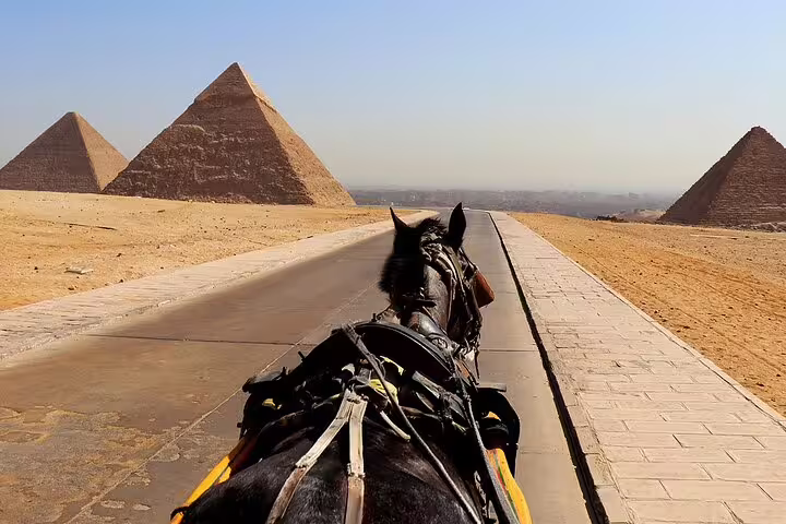 Horse-drawn carriage ride toward the Giza Pyramids on a half-day tour in Cairo desert landscape