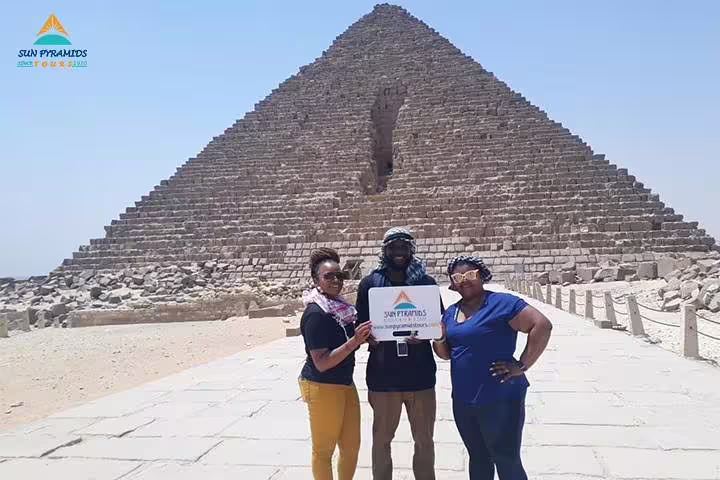 Group photo at Giza Pyramid entrance on guided Cairo tour featuring Memphis, Dahshur, Saqqara and El-Moez Street