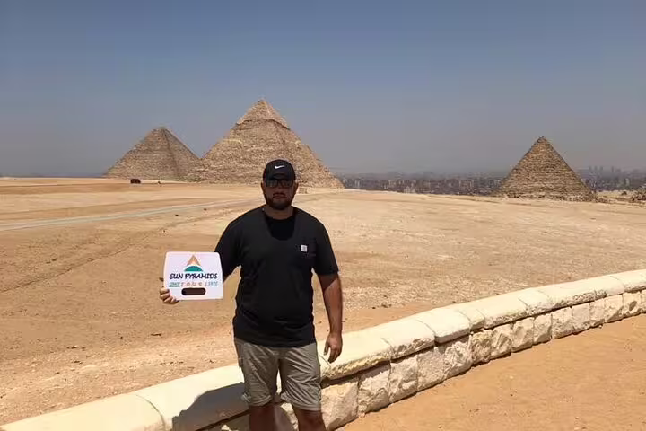 Guest at Giza Plateau with the Great Pyramids behind, part of a private Cairo tour including museum and Citadel