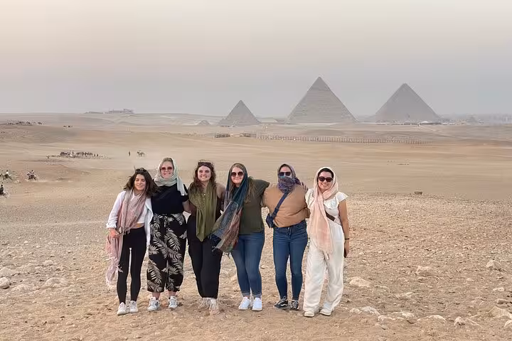 Group photo in Giza Desert with pyramids behind, quad bike tour stop with transfers and complimentary drinks