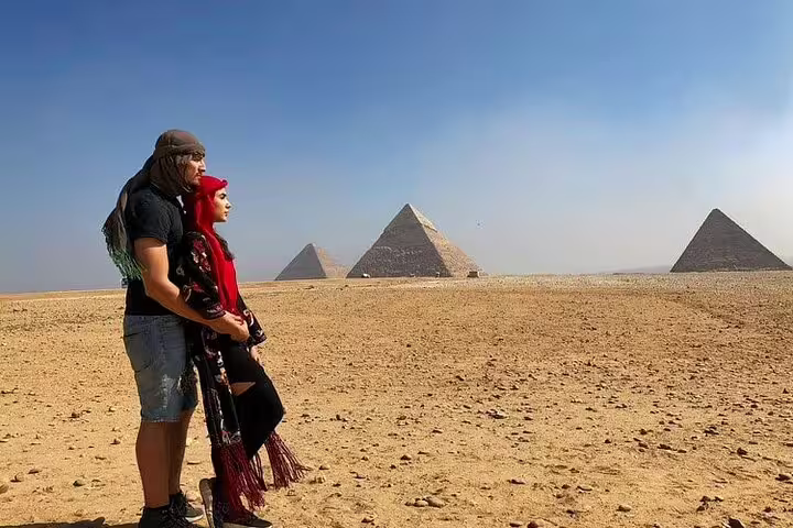 Couple watching the Giza Pyramids in the desert on a private Alexandria Port shore excursion to Giza and Saqqara
