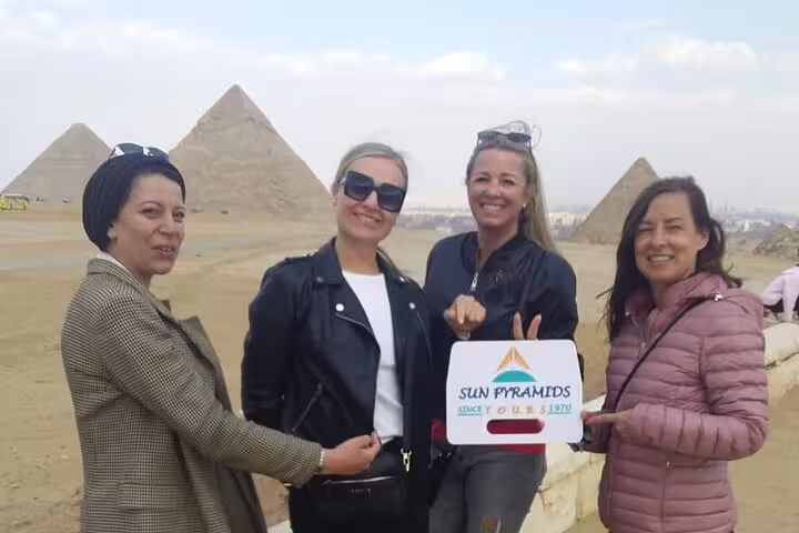 Private guided tour guests pose at Giza Pyramids, Cairo hotel or airport pickup for Sphinx visit