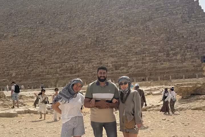 Private Giza Pyramids tour photo with guide and travelers at the Great Pyramid of Khufu in Cairo