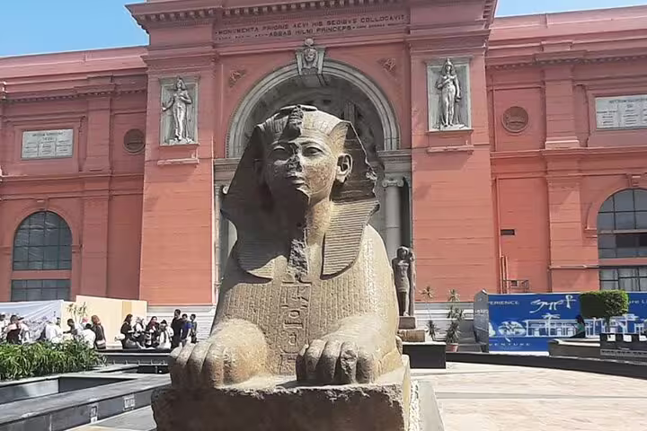 Egyptian Museum Cairo entrance with sphinx statue, private tour stop after Giza Pyramids and Sphinx visit