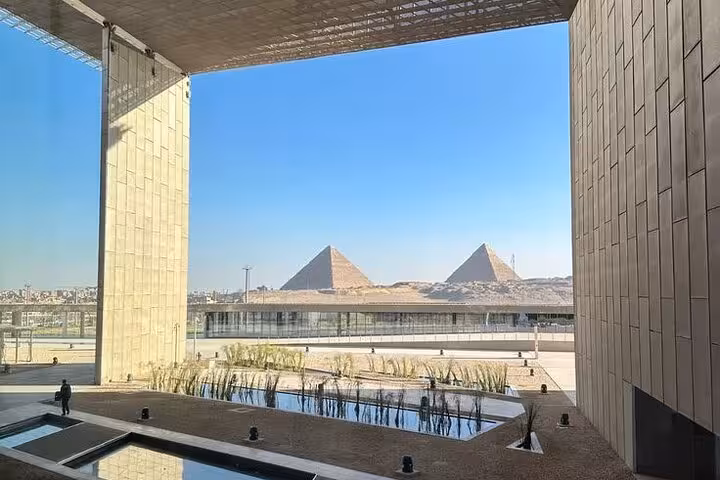 View of the Giza Pyramids framed by the Grand Egyptian Museum architecture, included in guided Cairo tour