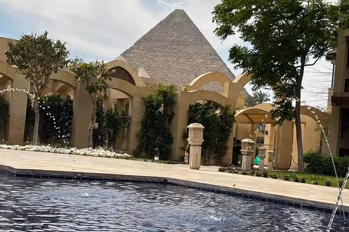 Giza Pyramid view beside hotel-style pool and arches, near private pyramids and Sphinx tour with lunch