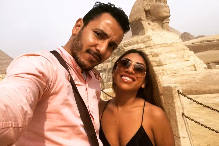 Couple selfie by the Great Sphinx on a private Giza Pyramids tour with quad biking, camel ride and tickets