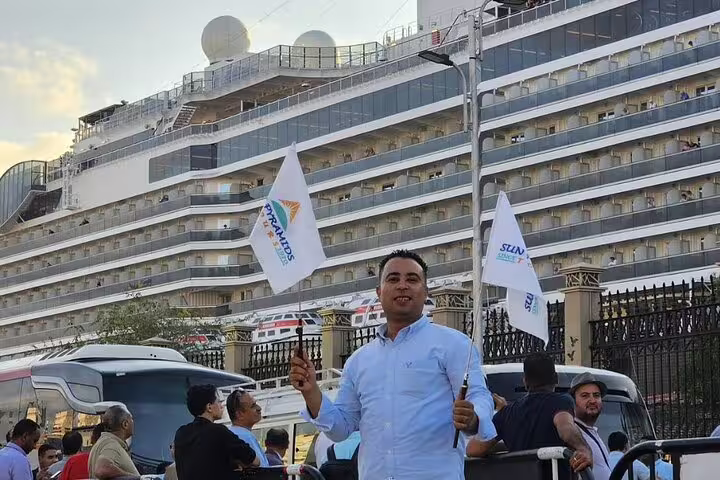 Tour guide welcomes guests at Cairo port near cruise ship for private full-day trip to Giza Pyramids