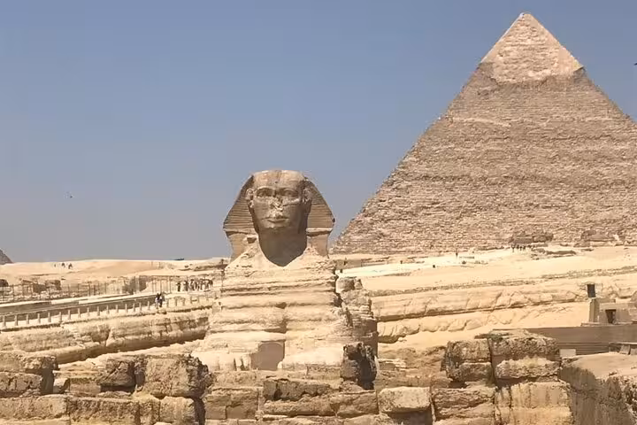 Great Sphinx and a Giza Pyramid under clear sky on private Giza tour featuring Sphinx visit, ATV and lunch