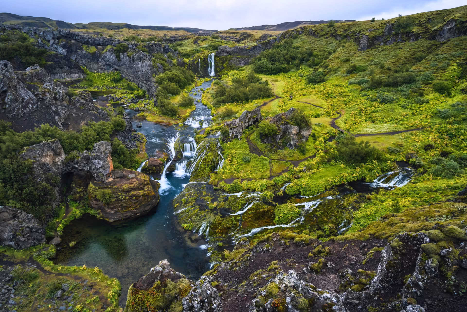 Gjáin gorge waterfalls and lush green ravine in Þjórsárdalur Valley on a private Iceland day tour