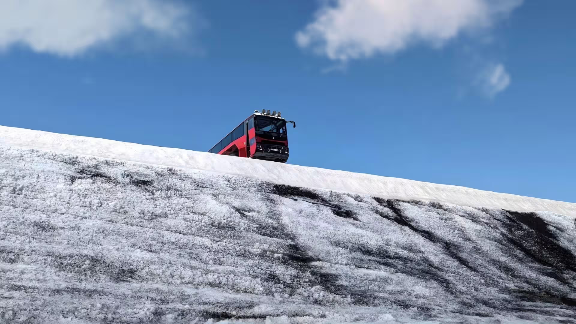Glacier monster truck climbing Langjökull ice ridge on the Ice Cave and Glacier Tour from Gullfoss, Iceland